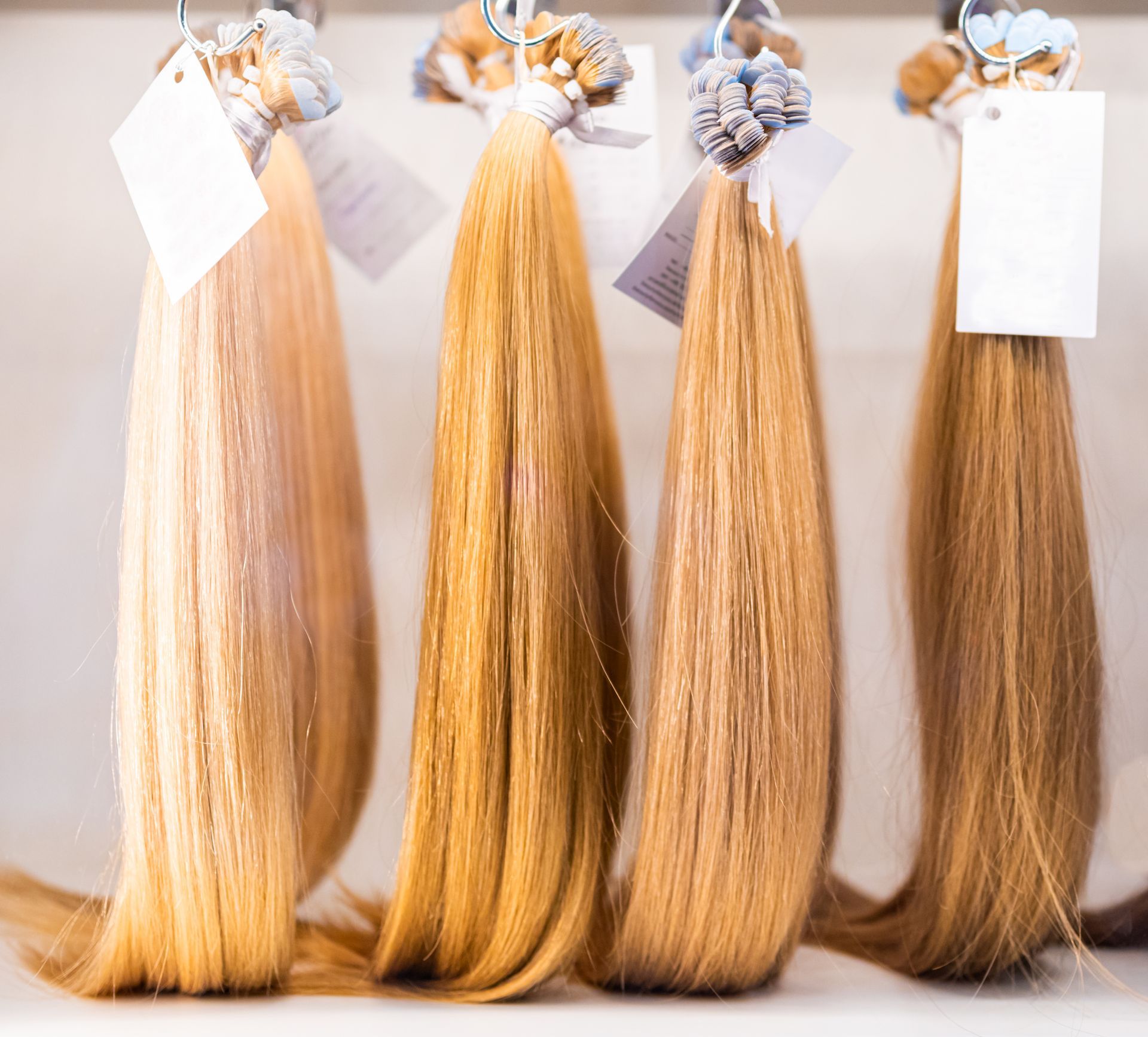 Blonde and brunette hair extension samples displayed for color matching at a salon consultation