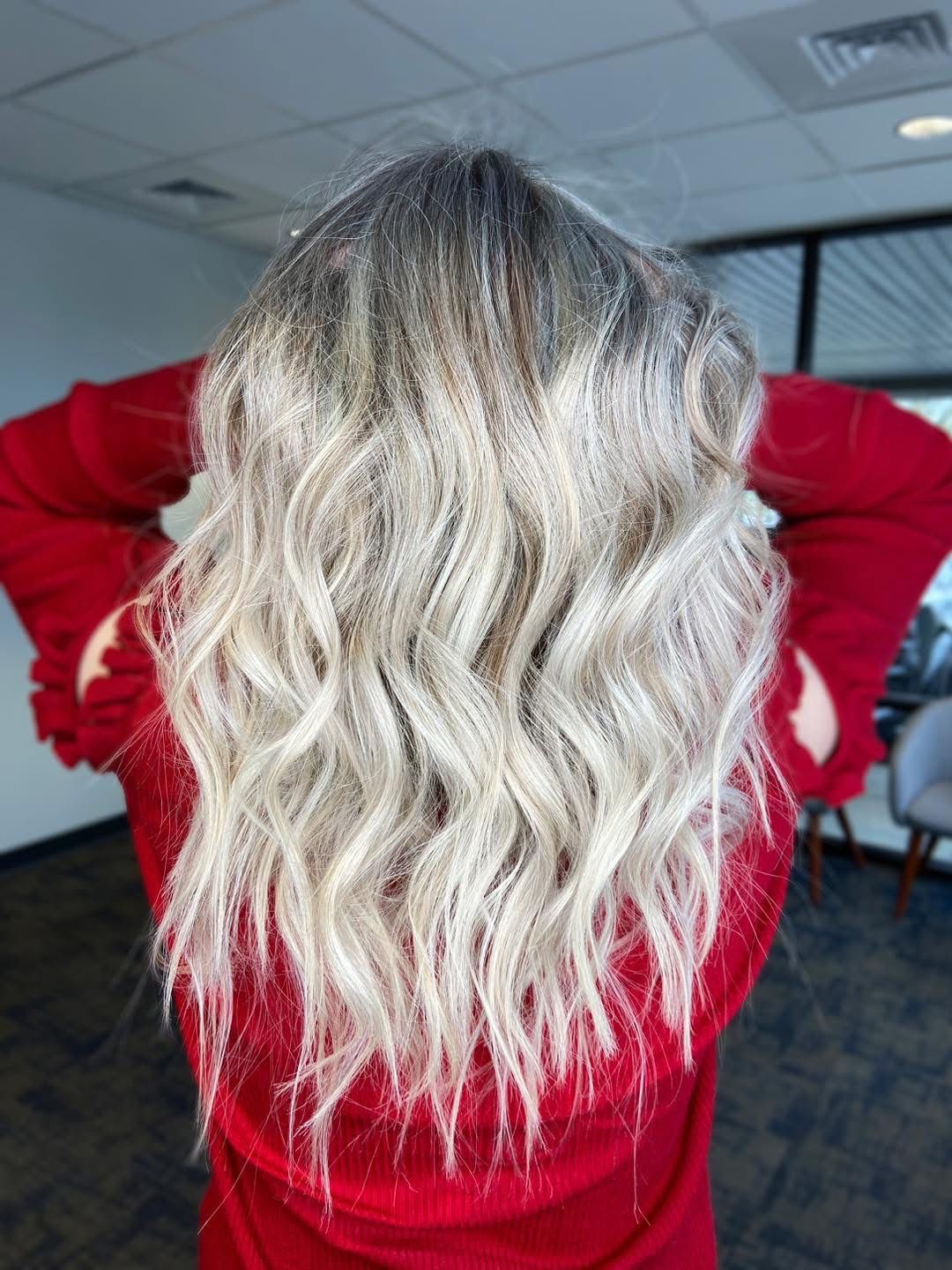 Dimensional platinum blonde hair with soft waves created by a blonde specialist in Willard, MO.