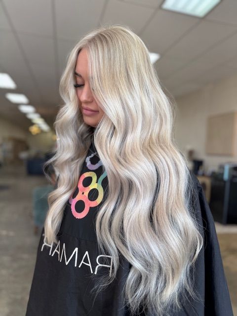 Long platinum blonde hair with dimensional color and soft waves by a blonde specialist in Nixa, MO.