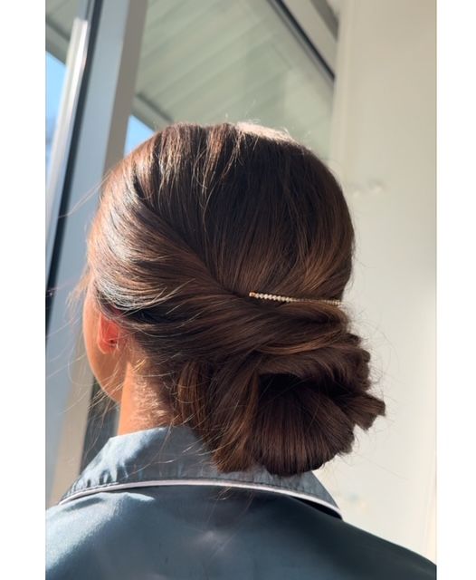 Elegant low bun wedding updo created by a professional hair stylist in Rogersville, MO.