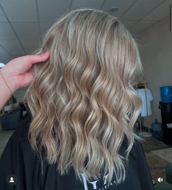 Dimensional blonde hair color with soft waves by a blonde specialist in Battlefield, MO.