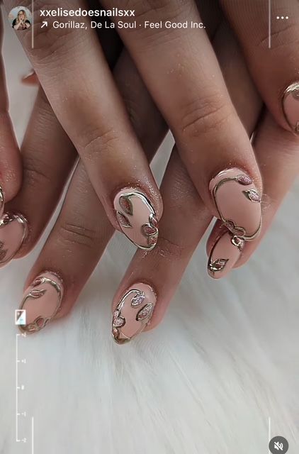 Neutral chrome custom nail art with detailed 3D designs by a nail artist in Brookline, MO.