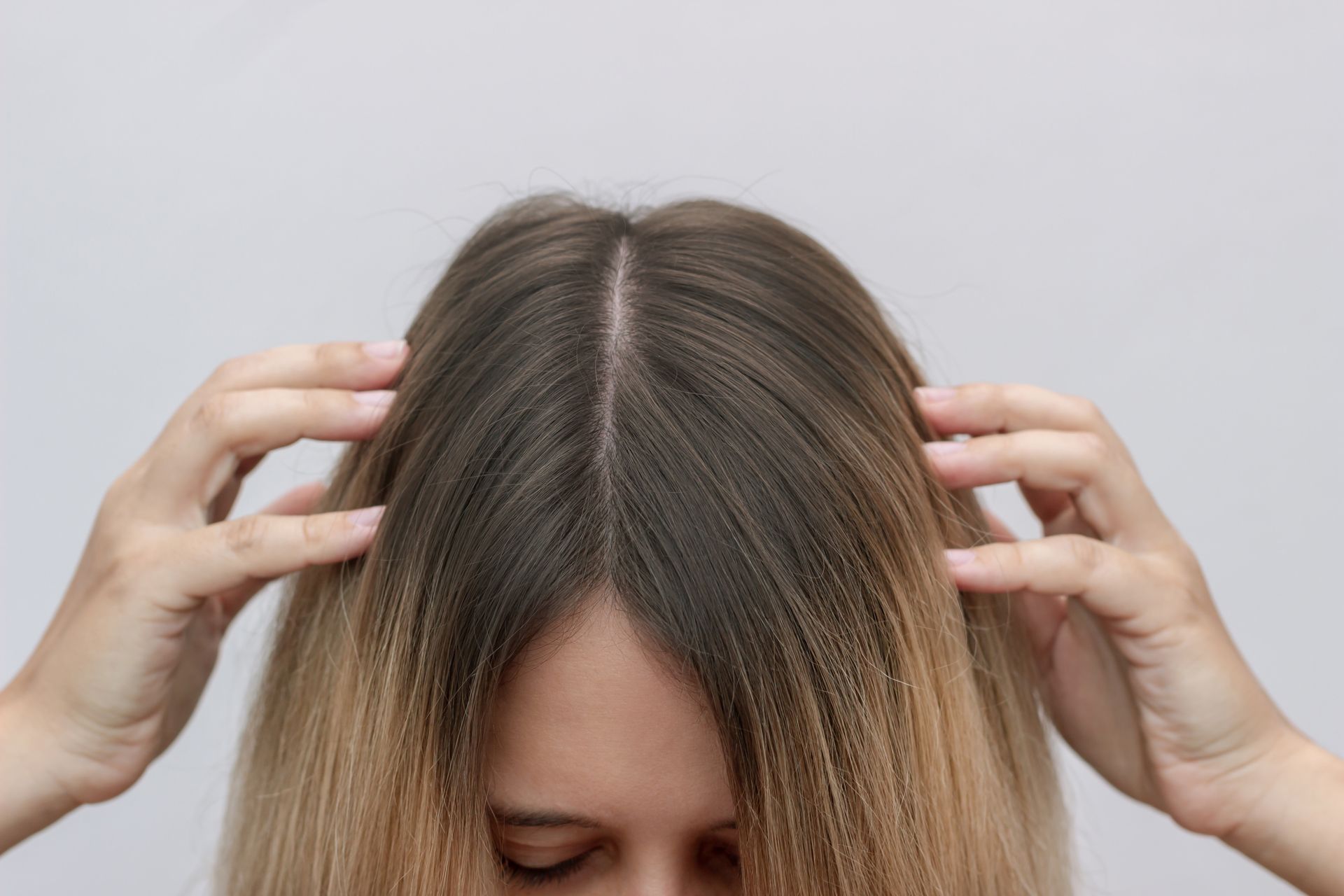 woman with grown out roots | Root touch ups at top hair salon in Springfield MO