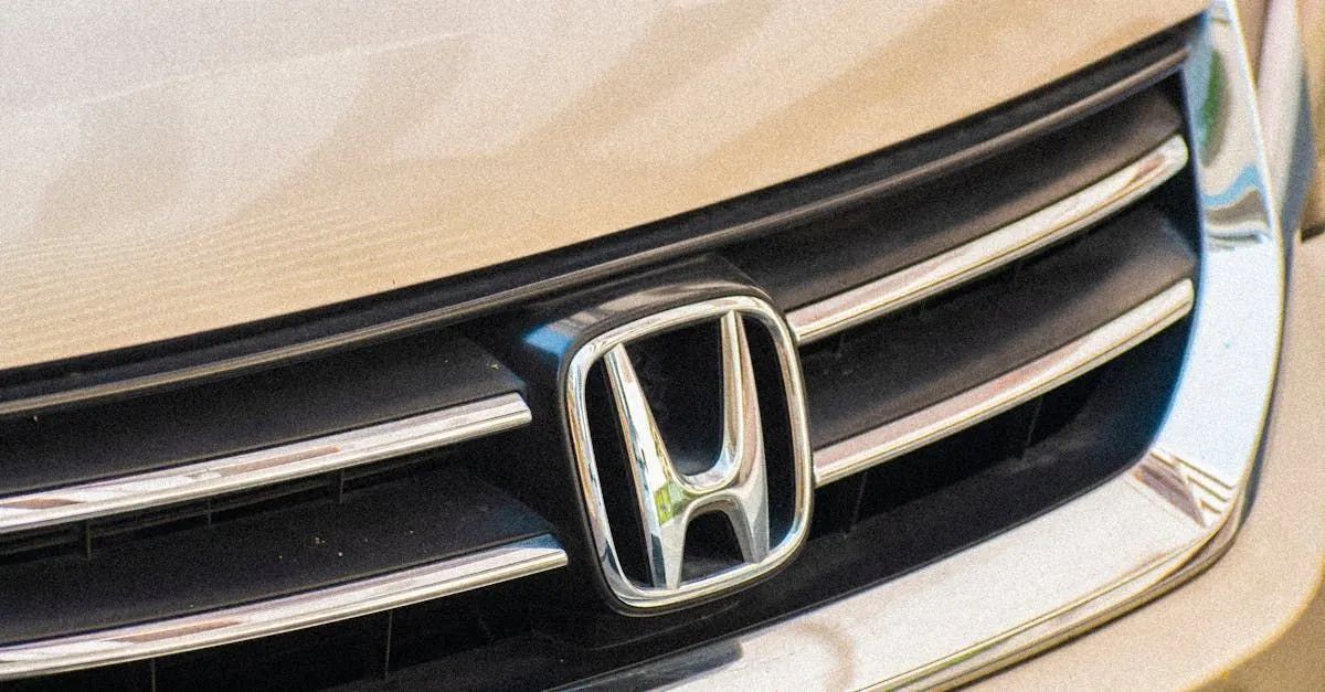 Close-up of a Honda car grill with the Honda emblem in the center, chrome trim.