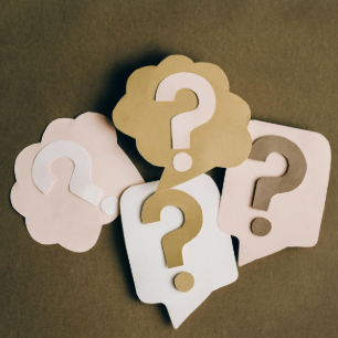 Thought bubbles with question marks in beige, white, and brown on a green background