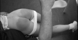 Mature male disciplinarian administers a good sound spanking to female client