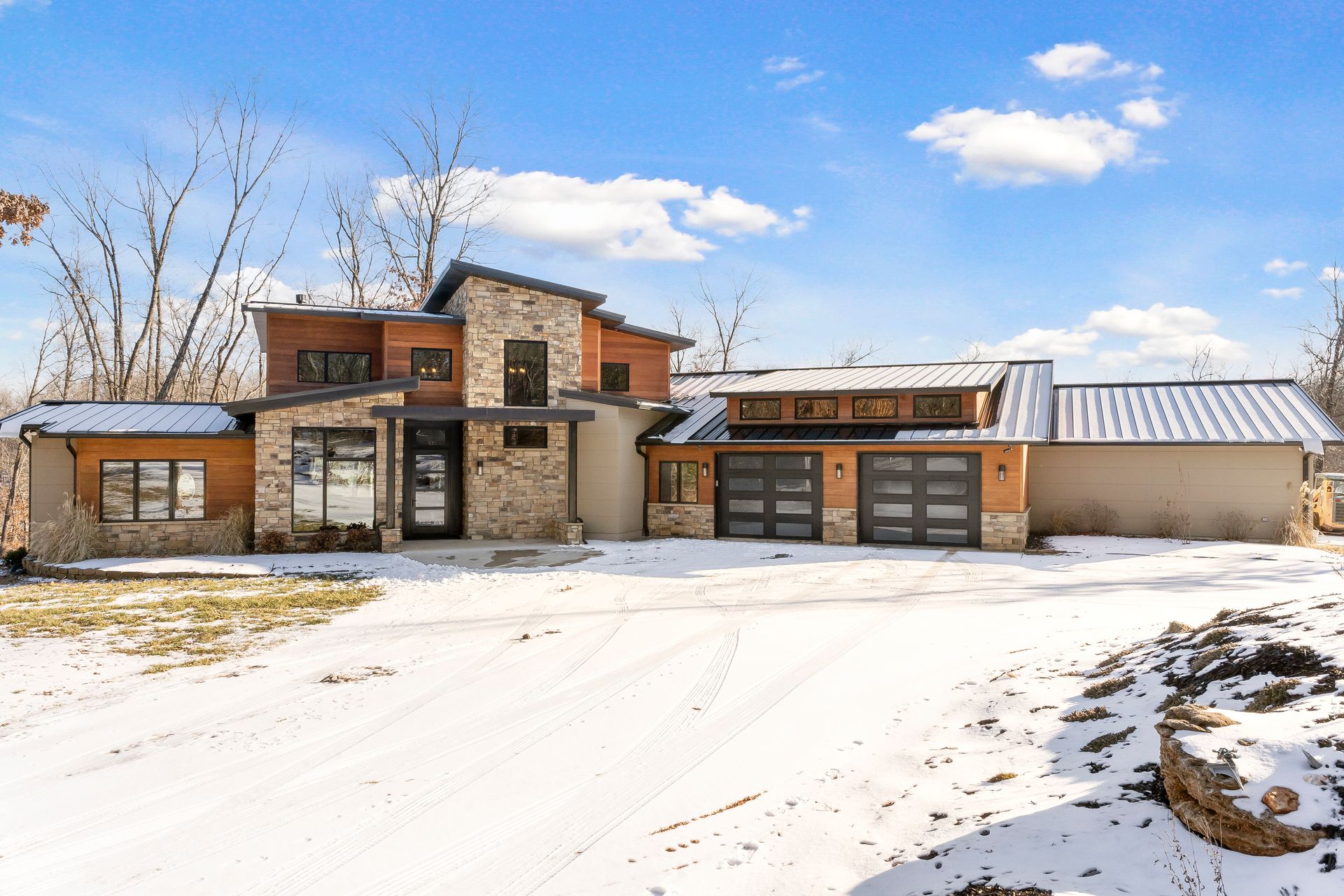 Custom ICF home with mixed stone and wood veneer exterior | Sparta, MO