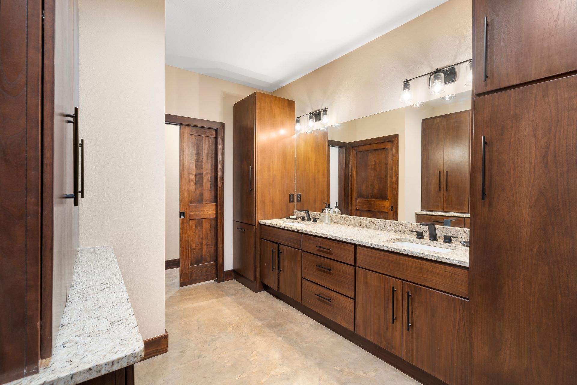 A bathroom with two sinks and a large mirror- icf block installer springfield mo