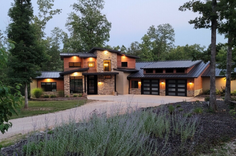 A large ICF house is surrounded by trees and grass- custom houses - sustainable home design ideas in Ozark MO