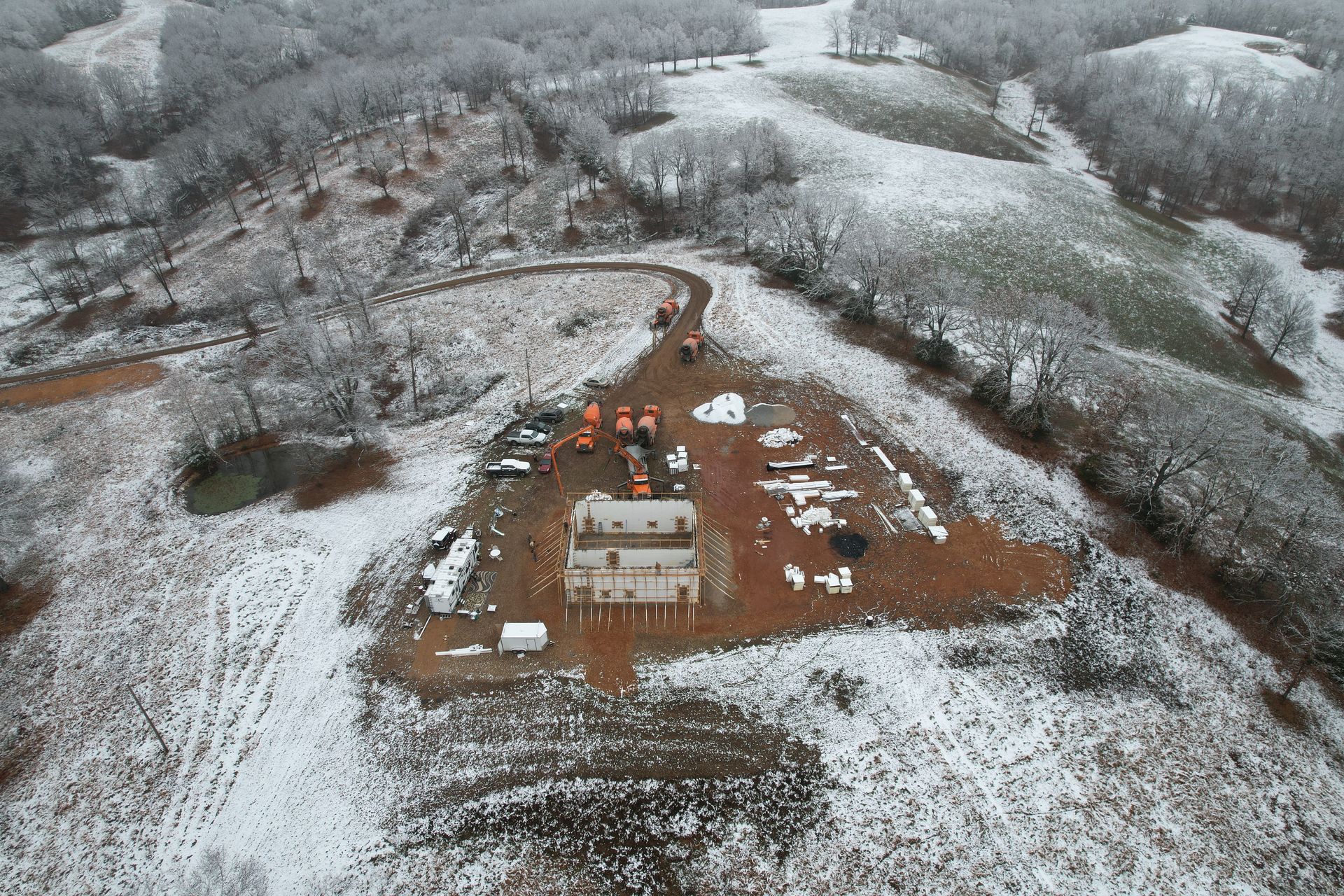 Concrete pump truck and insulated concrete form home in winter | Nixa, MO