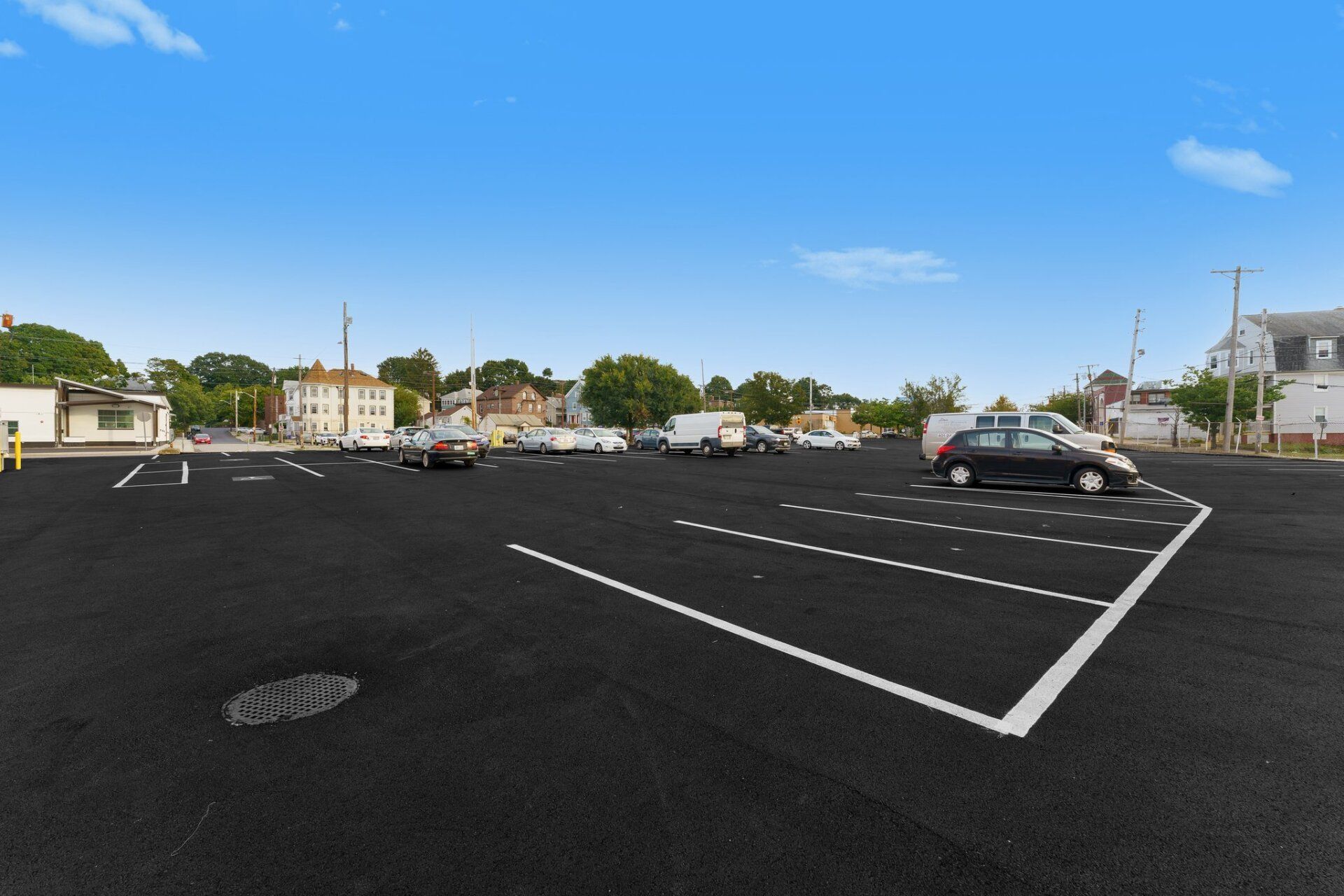 a parking lot with a new paved driveway