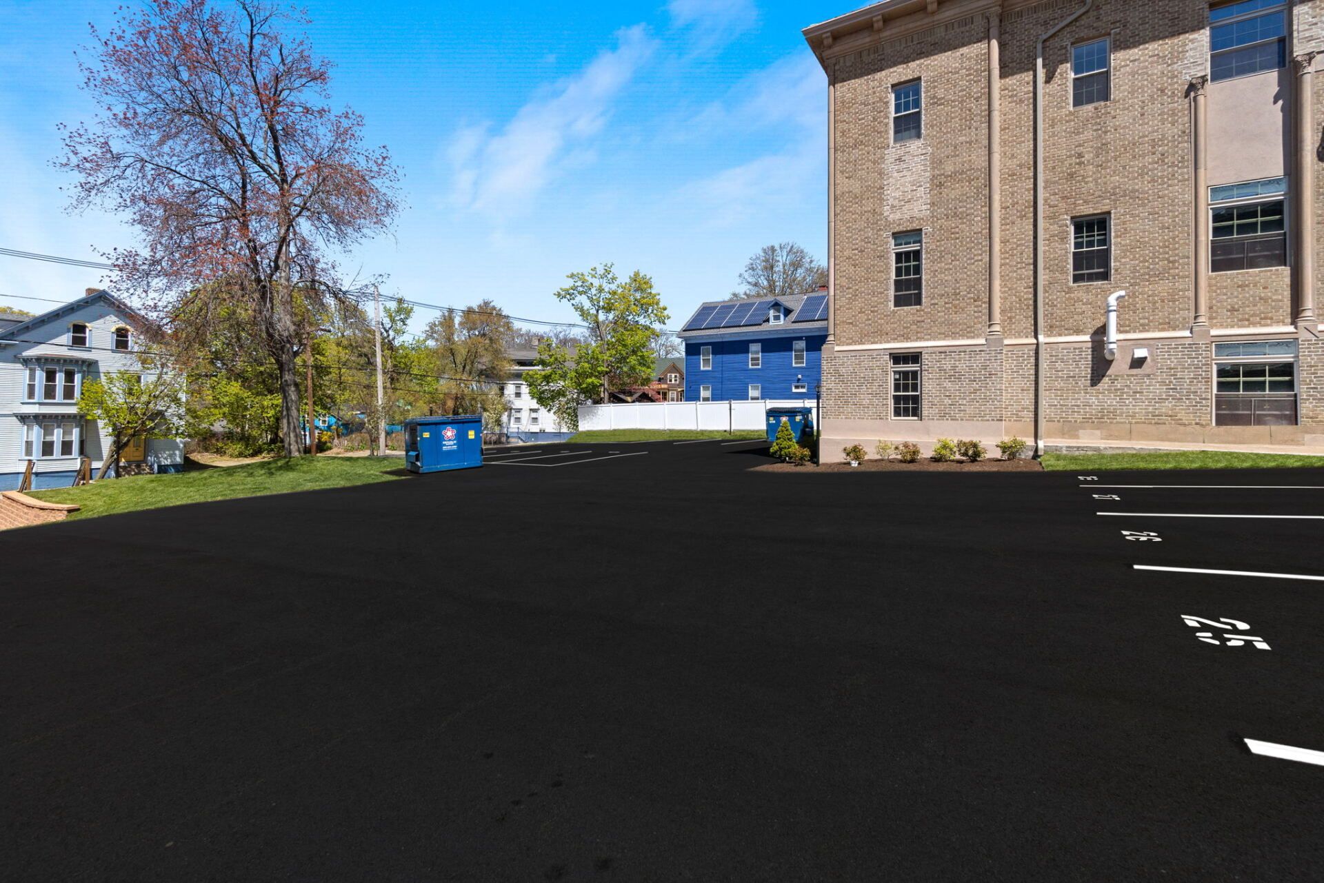 a parking lot with a new paved driveway