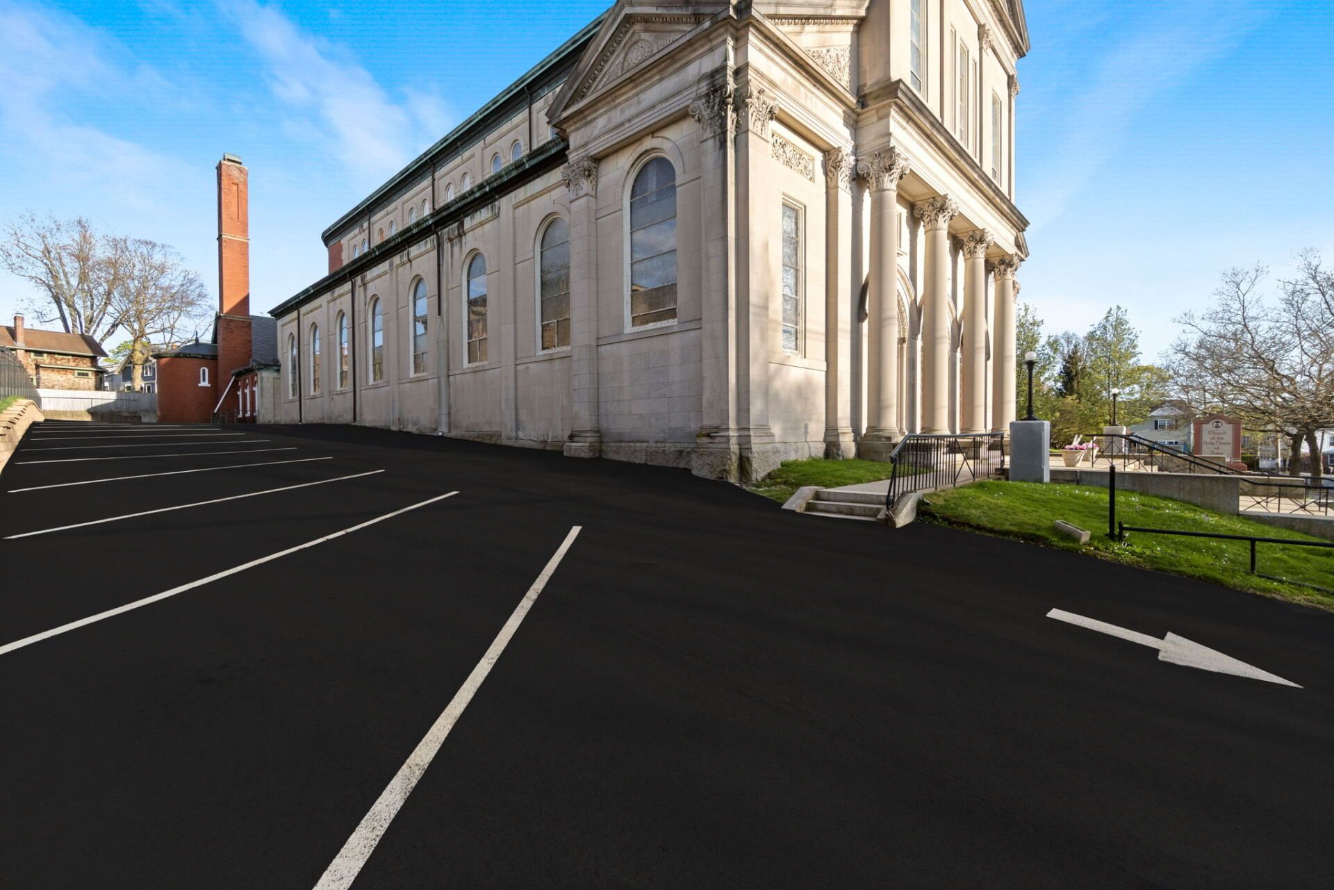 a parking lot with a new paved driveway
