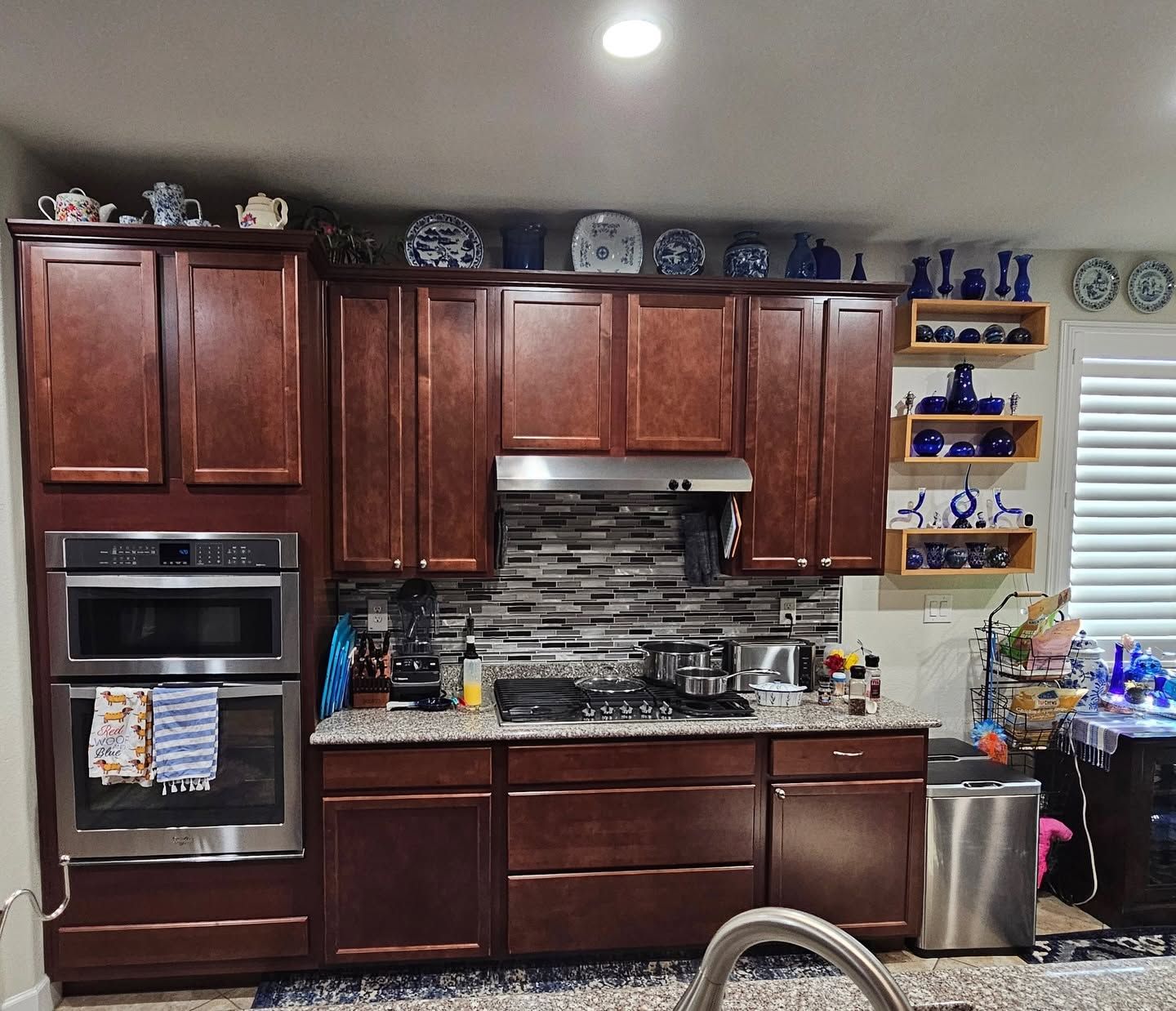 Bright modern kitchen with island seating, stainless fridge, and pendant lights