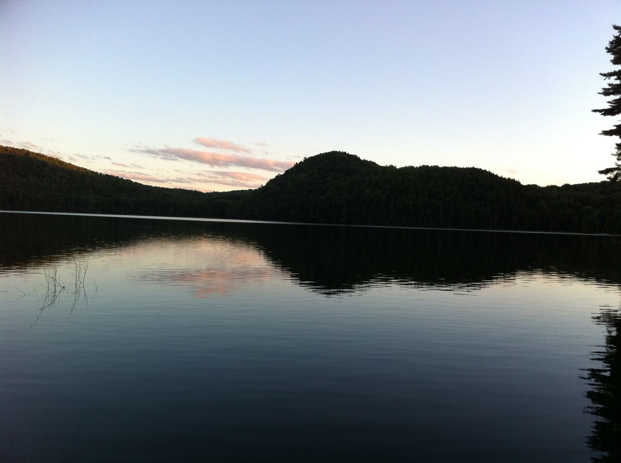 A mountain reflecting on a lake at sunset