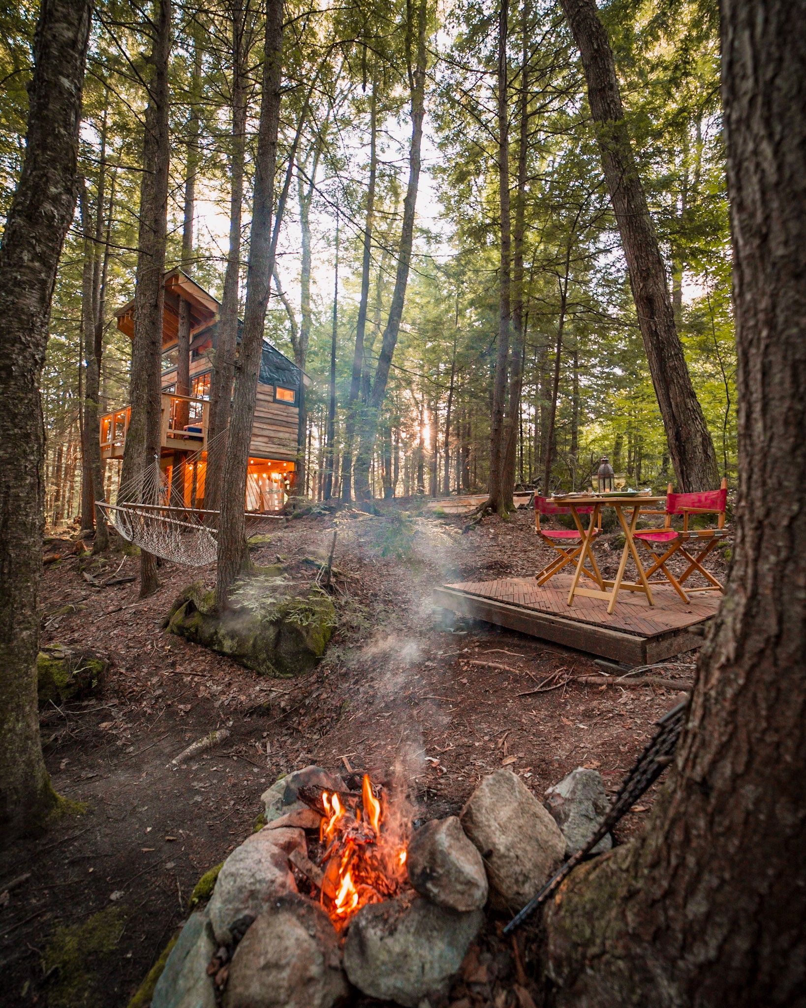 The treehouse site with a fire in the foreground