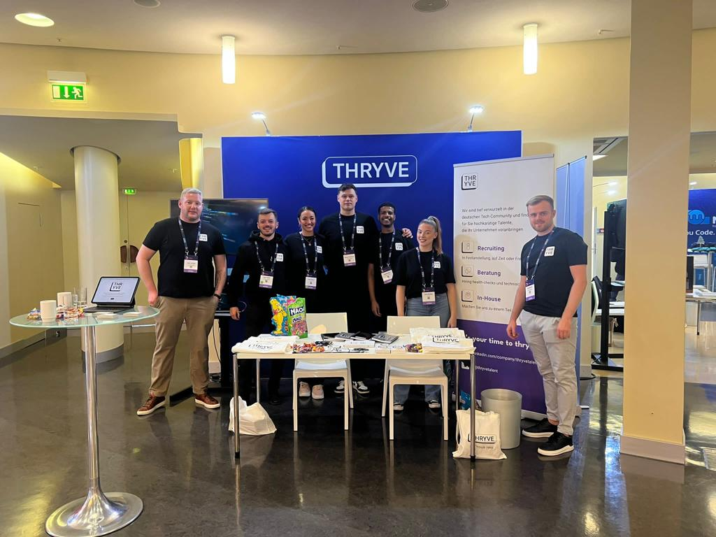 People at a trade show booth with a blue