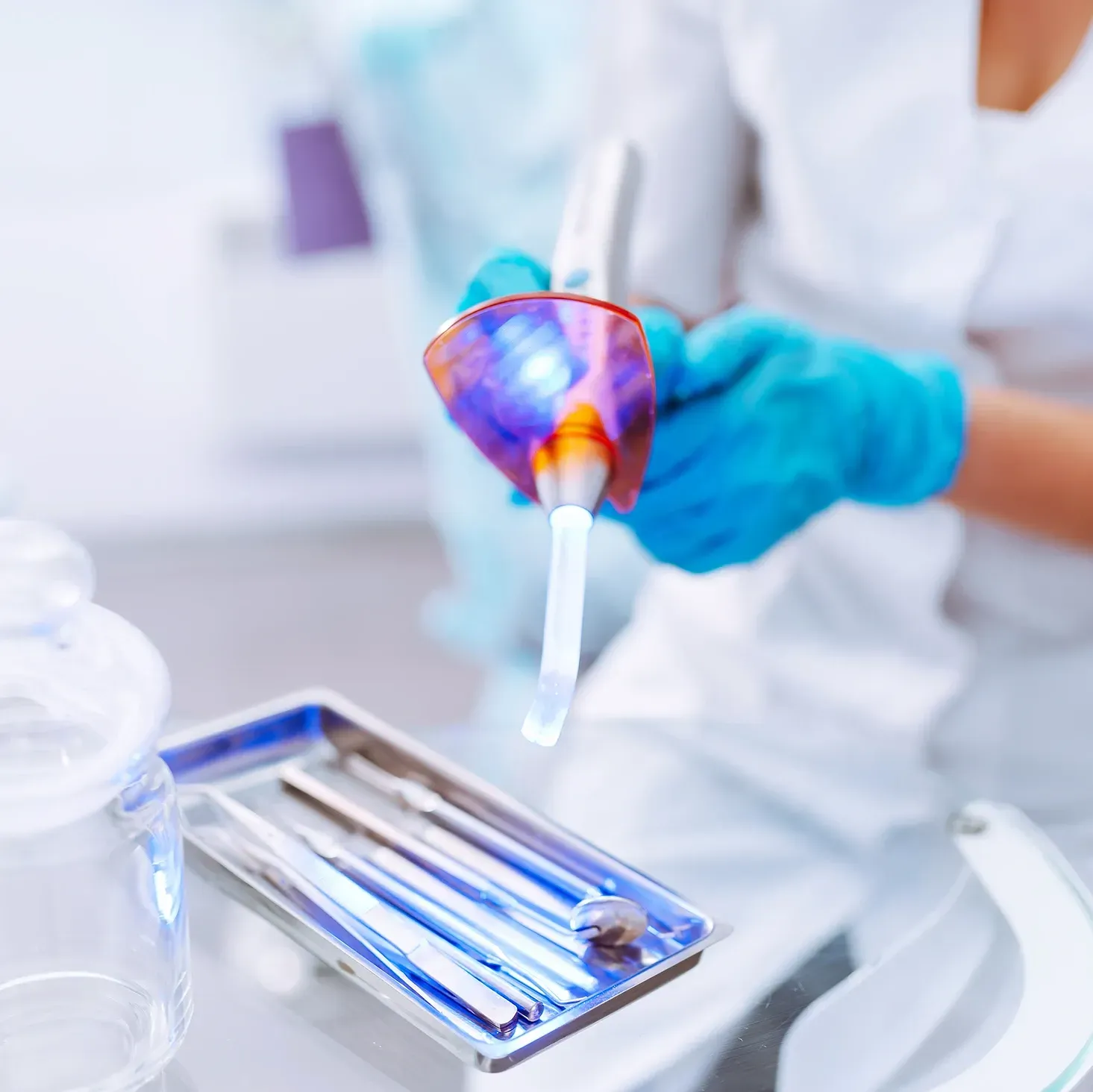 A close of dental tool being cleaned by a portable UV light