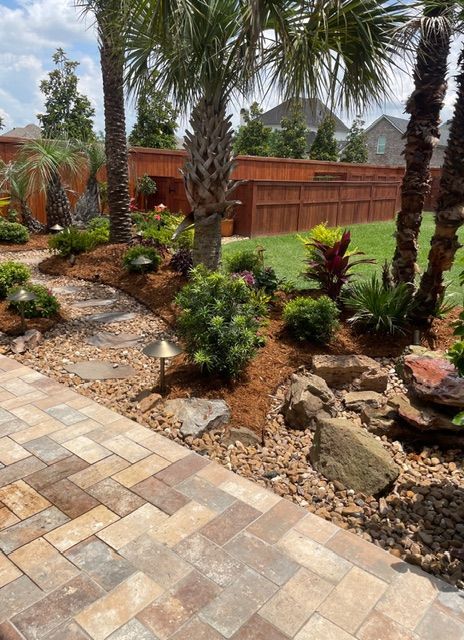 Beau Monde landscape installation includes patio, fresh mulch, stone features, walkway Lafayette, LA