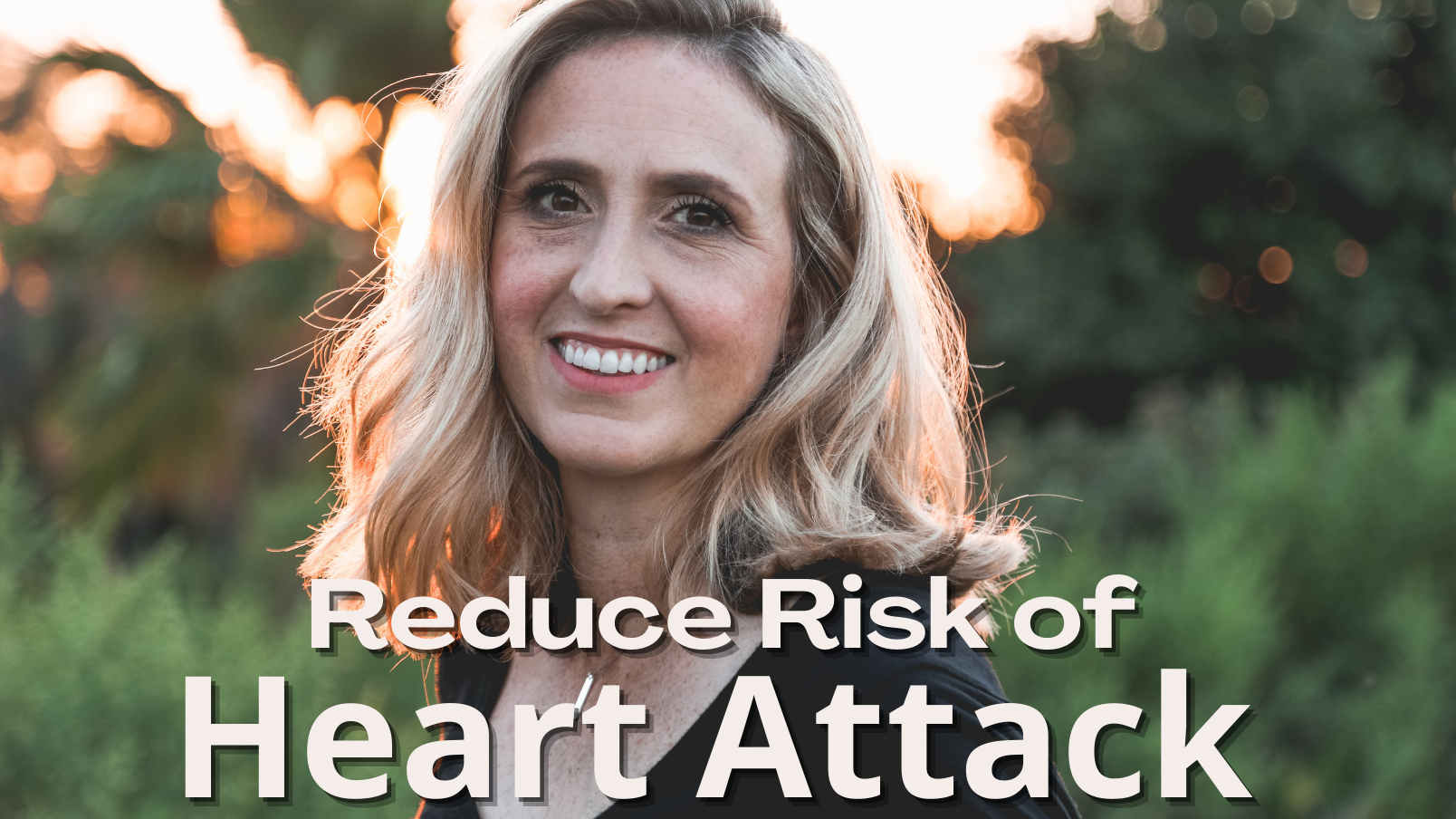 A woman is smiling in a field with the words `` reduce risk of heart attack ''.