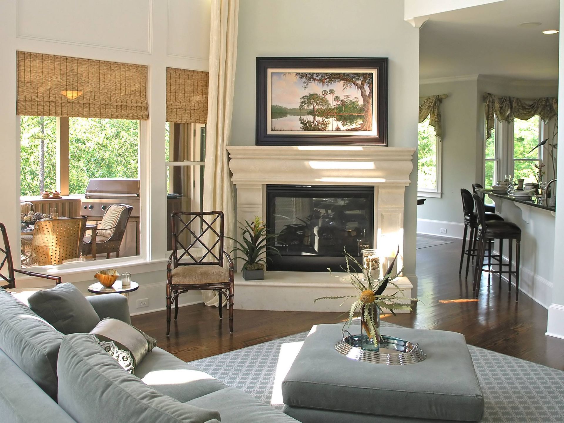 A cozy living room with custom window treatments on the windows overlooking the back patio