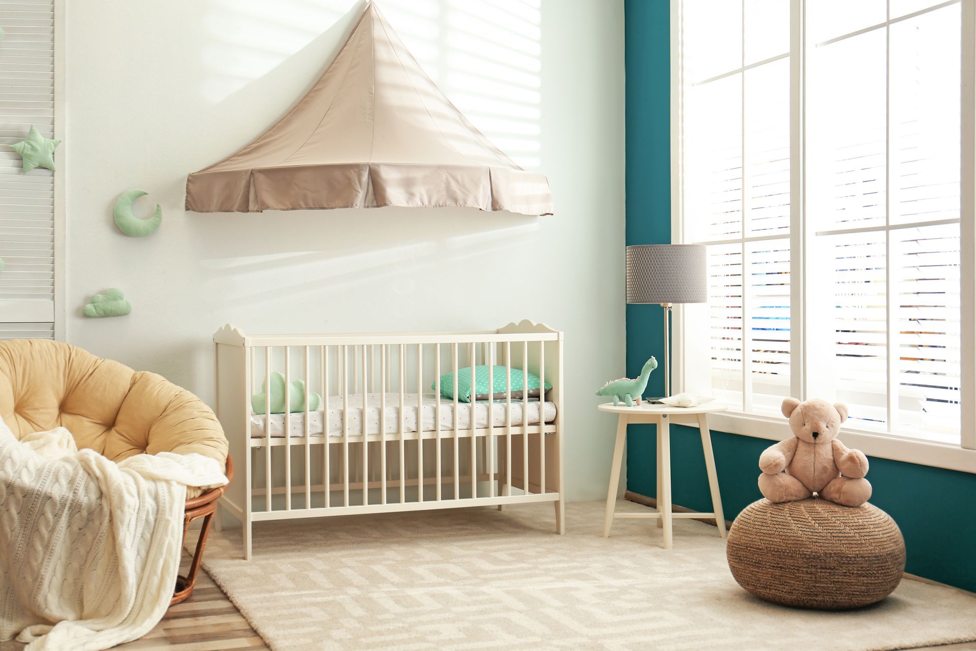 A sweet nursery balancing bold and pastel colors with cordless blinds on the window 