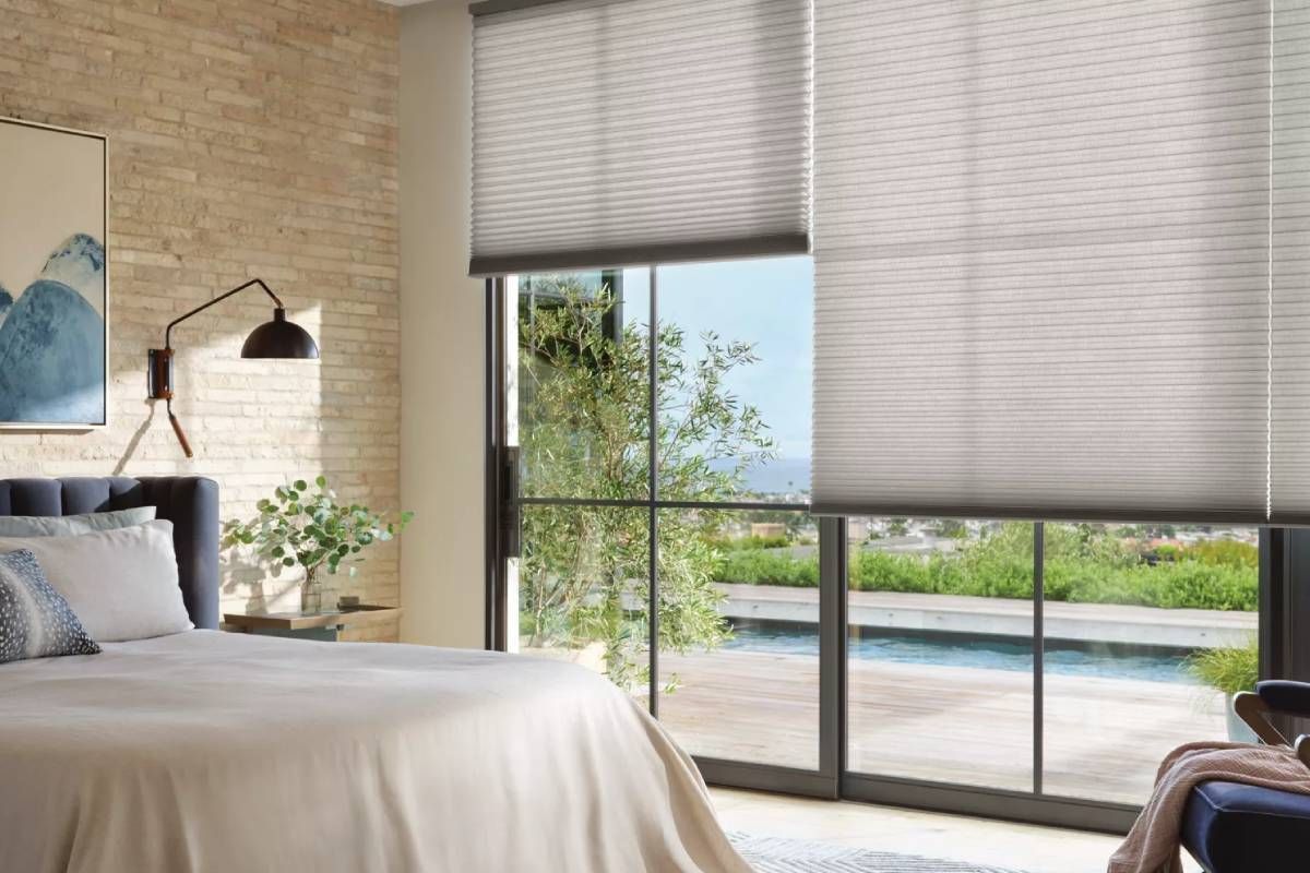 Hunter Douglas Duette® Cellular Shades on, partially lifted up, on windows in a stylish bedroom