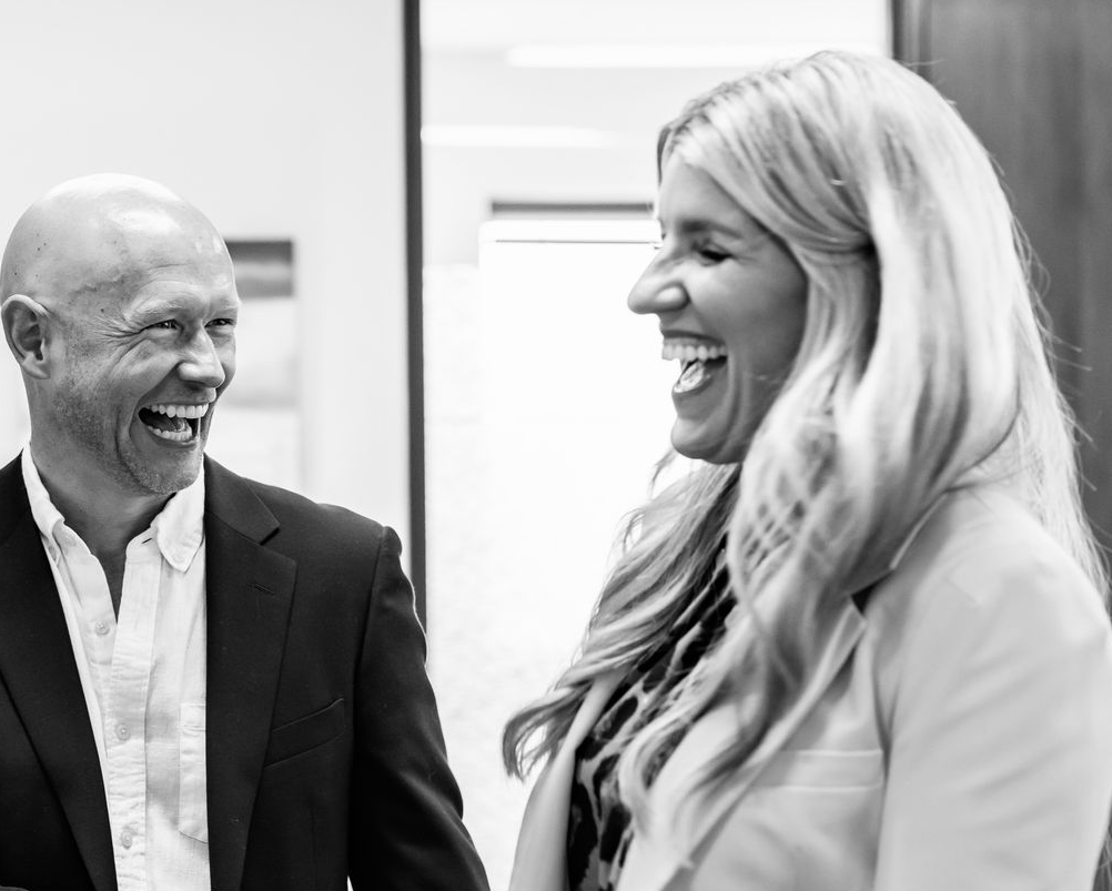 Allison Madrigal and friend in office setting smiling while in conversation