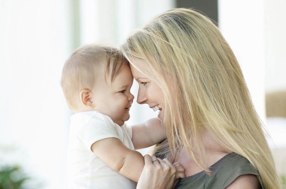 Mother holding small baby on IVF Insurance page