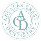clicking this will go back to home Angeles Crest Dentistry logo in pale teal with circular text and stylized ACD monogram