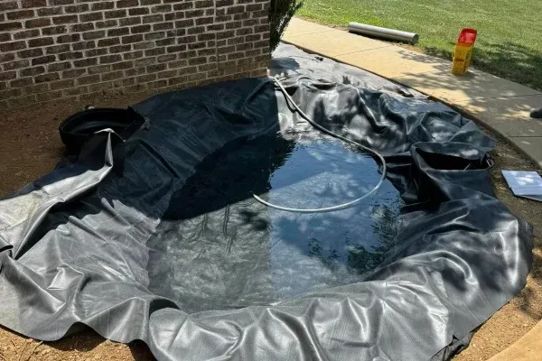 Decorative garden pond installation in Spring Grove PA adding visual appeal and tranquility to landscape designs