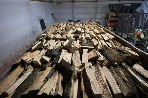 firewood stacking service in Spring Grove PA organizing delivered wood for convenient storage and easy access