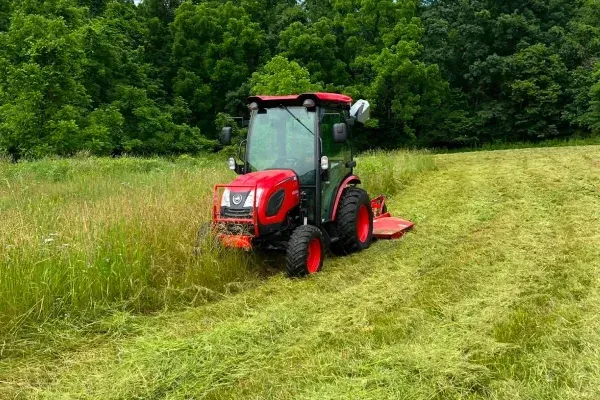 Overgrown field clearing in Spring Grove PA cutting heavy brush and tall grass to restore usable land areas
