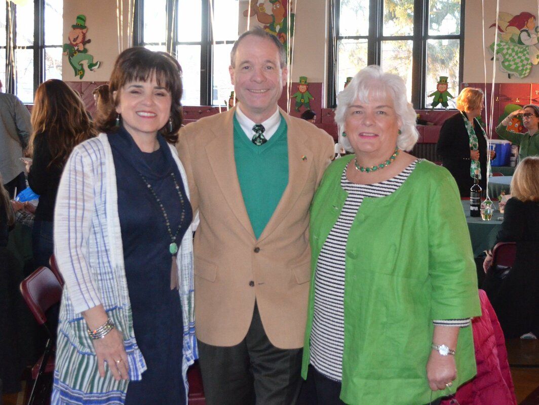 A man and two women pose for a picture together