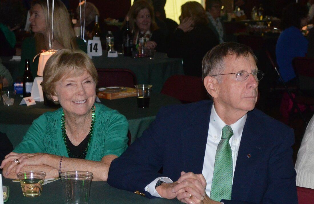 A man and woman sit at a table with a table number 14