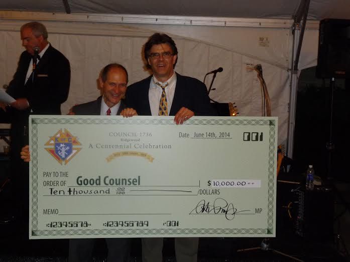 Two men holding a large check that says good counsel