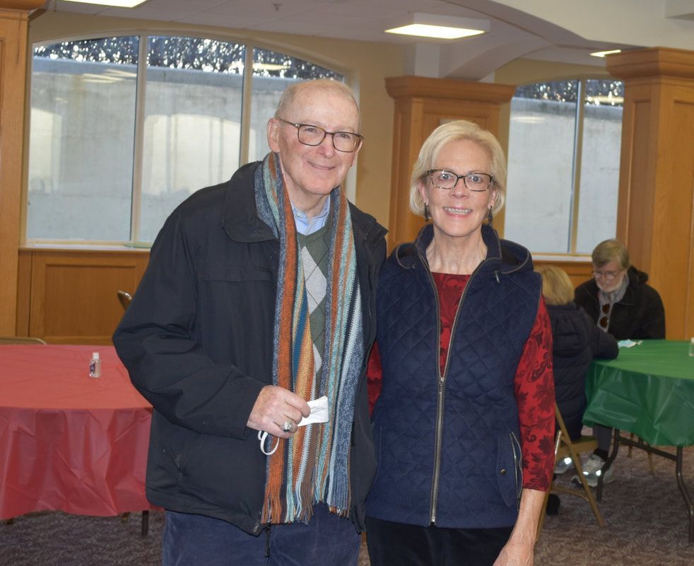A man and a woman are posing for a picture in a room