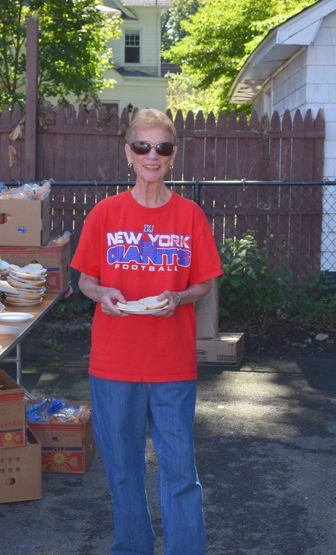 A woman wearing a red shirt that says new york on it