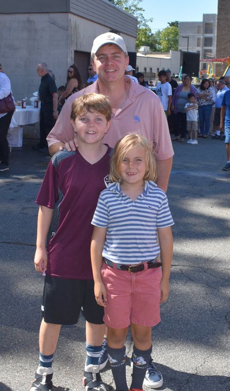 A man and two children are posing for a picture