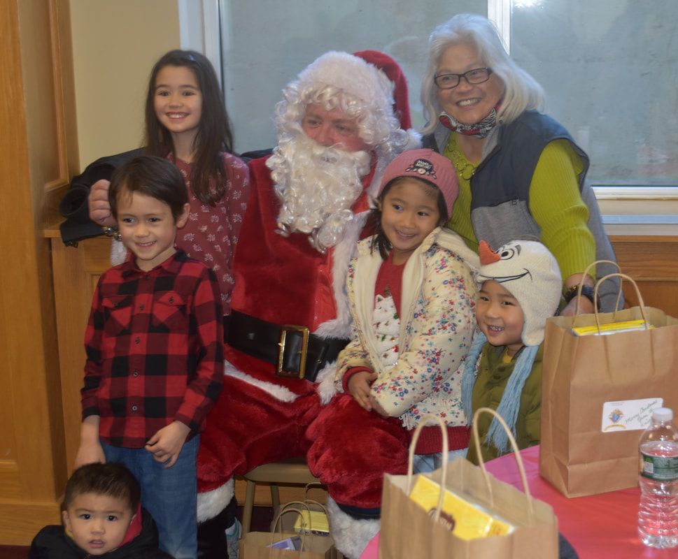 A group of children are posing for a picture with santa claus