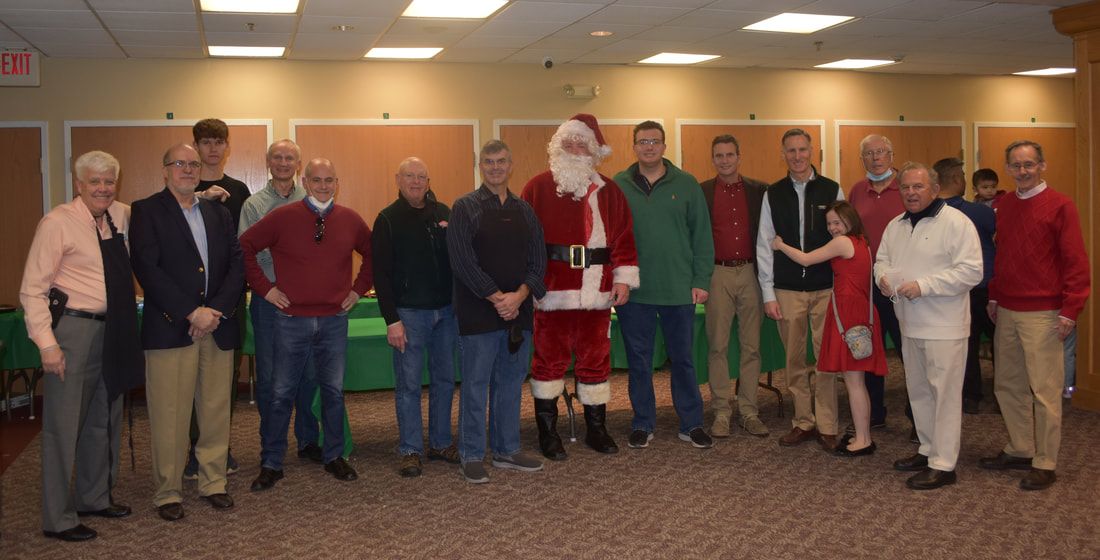 A group of people are posing for a picture with santa claus