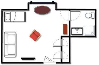 Floor plan of a studio apartment with furniture, including a bed, sofa, chair, and bathroom.
