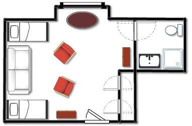 Floor plan of a hotel room with two beds, a sofa, chairs, bathroom, and furniture.