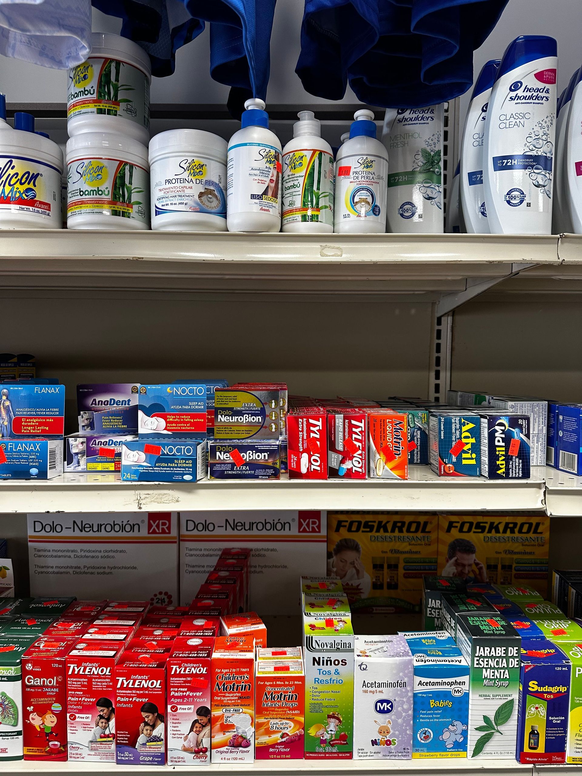Shelves stocked with assorted colorful household and food products in a store aisle