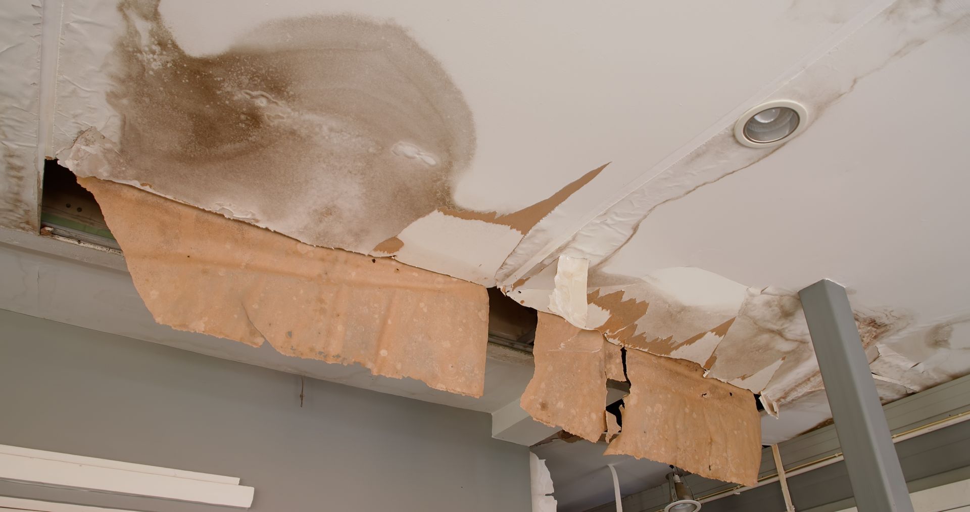 Water damage restoration for a ceiling with severe leaks and moisture damage.
