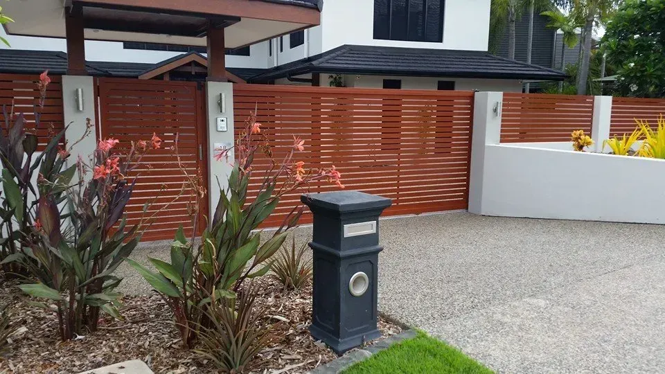 A brown fence and gate in front of a house — Fence Factory In Berrimah, NT