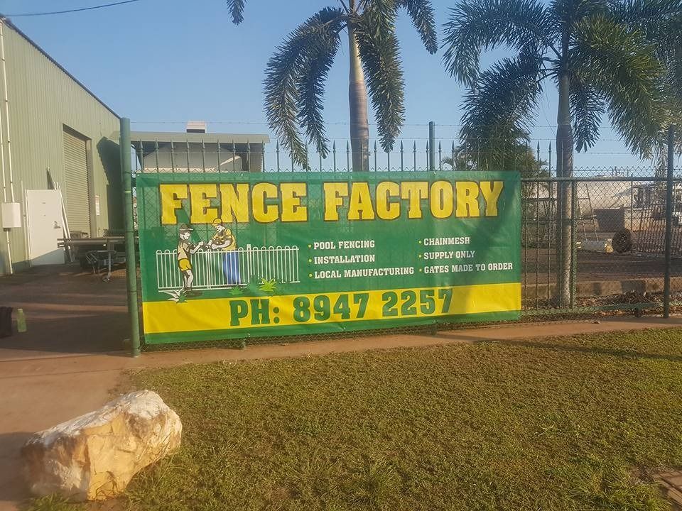 A large sign is on a green fence out the front of a shed — Fence Factory In Berrimah, NT