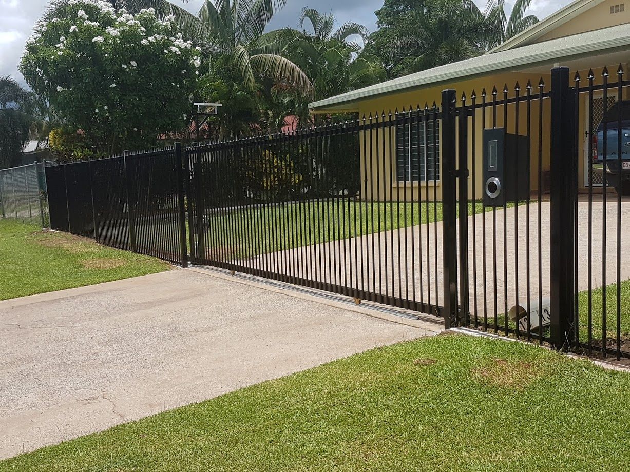 A Gated Driveway Leading to A House with Trees in The Background — Fence Factory In Tennant Creek, NT