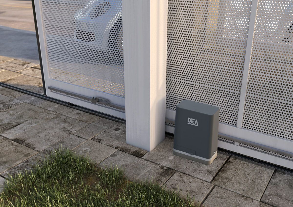A sliding white gate with gray metal frame next to a gray control box, on a paved area. — Fence Factory In Berrimah, NT