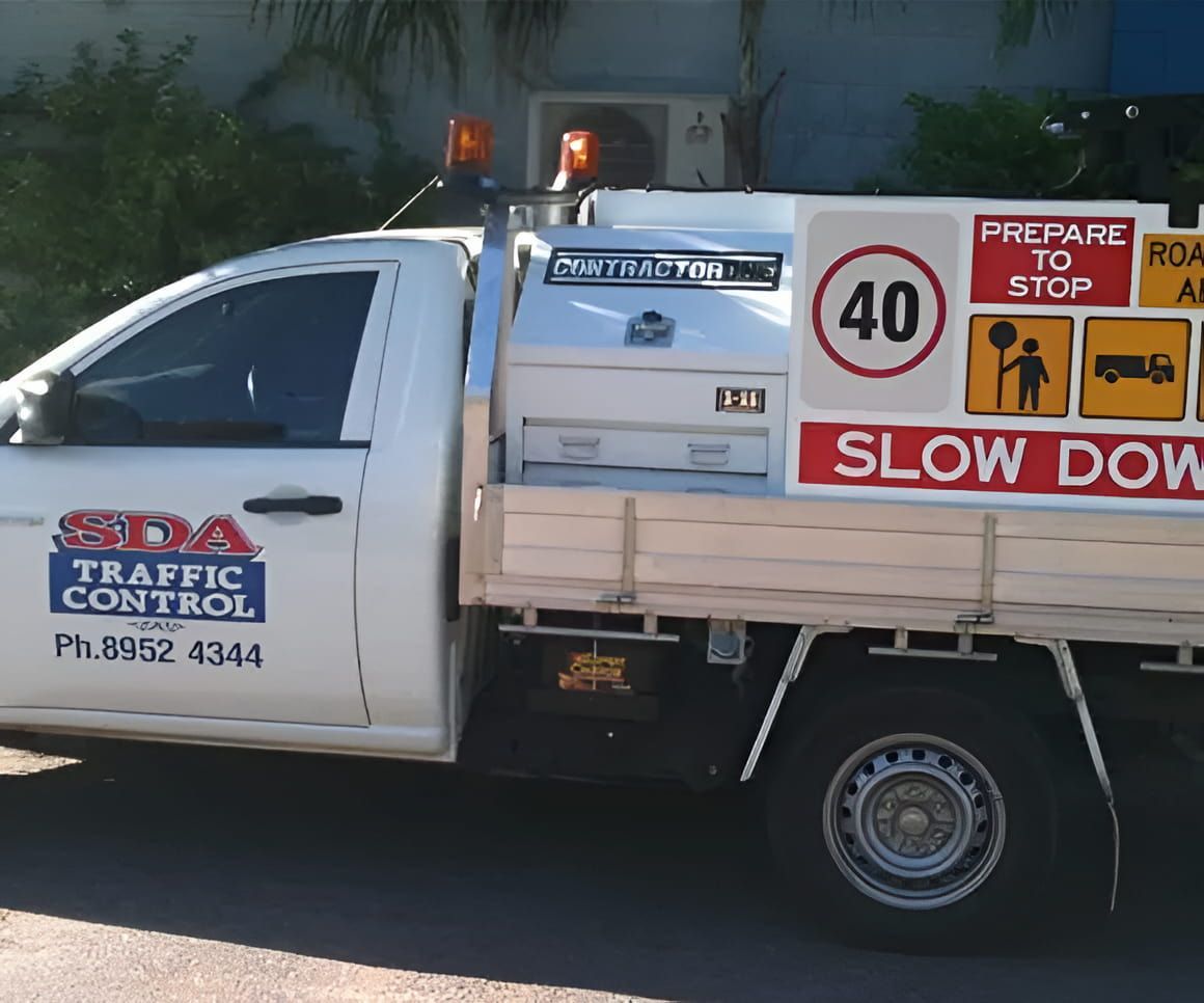 White Traffic Control Truck With Signage — SDA Plumbing in Alice Springs, NT